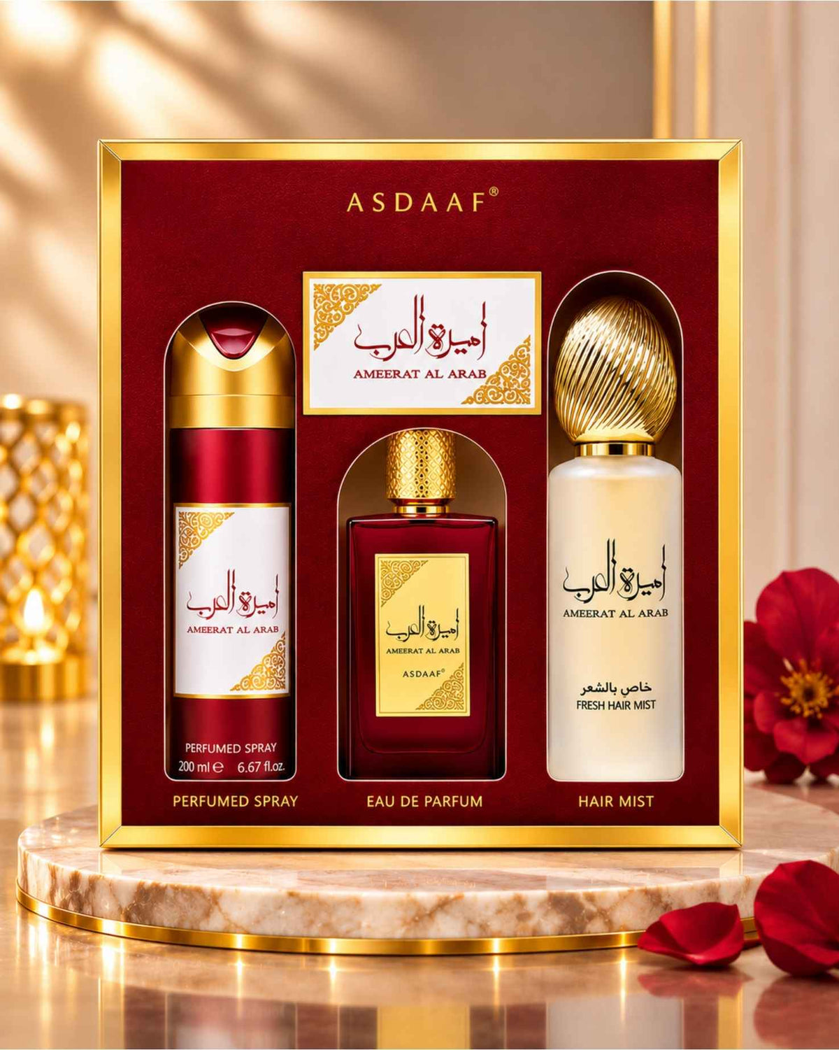 Asdaaf Ameerat Al Arab 3-piece perfume gift set in its red and gold presentation box, set on a marble pedestal with red rose petals and warm ambient lighting.