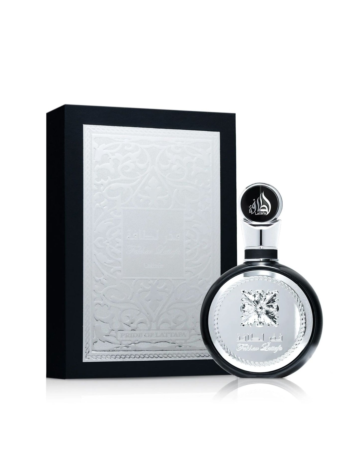 The Lattafa "Fakhar Lattafa" Eau de Parfum set, featuring a round black bottle with a large central silver panel next to its tall black box, which has an embossed silver panel with intricate filigree and text.