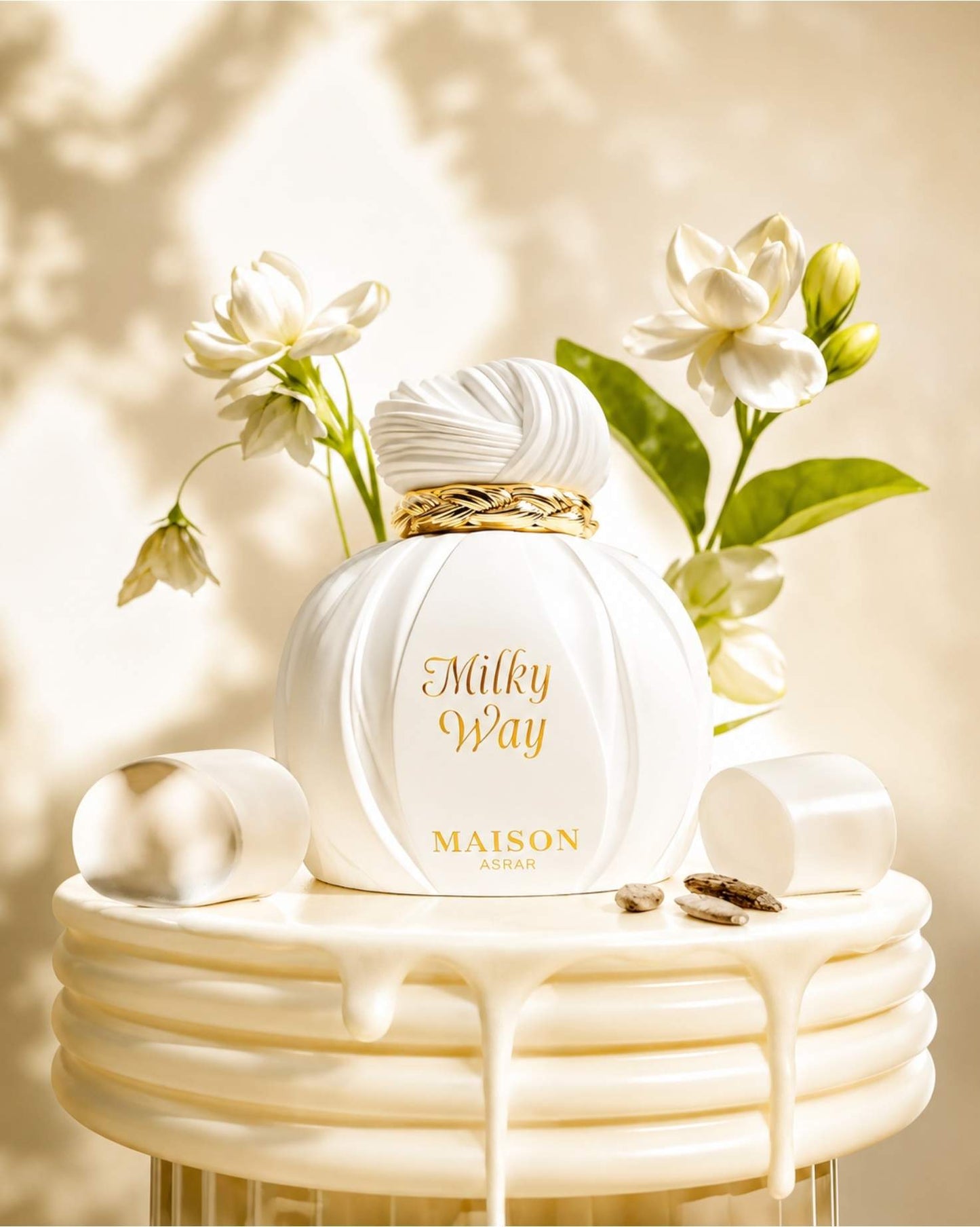 Maison Asrar Milky Way Eau de perfume bottle styled with white flowers, marshmallows, and creamy accents.