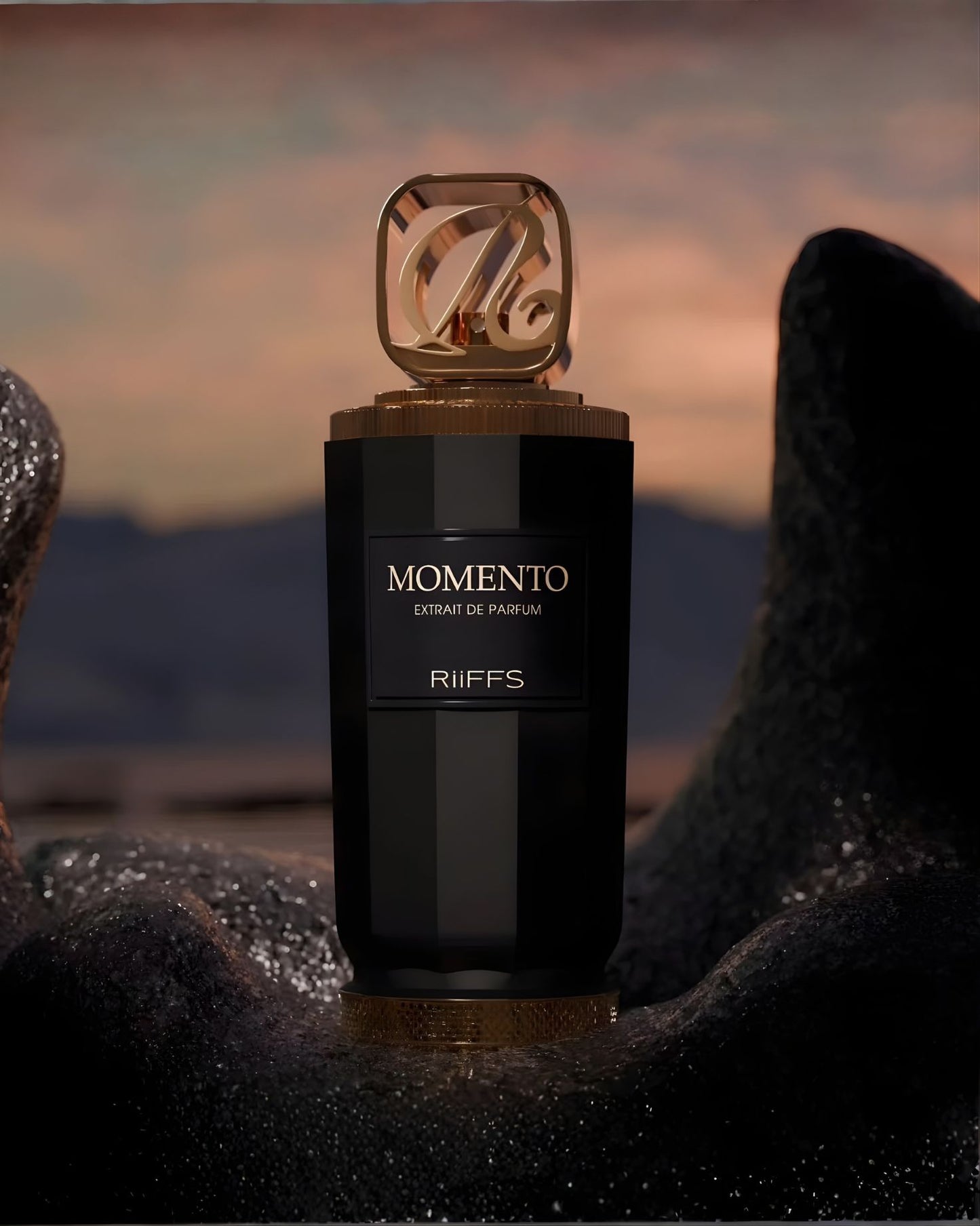 A striking close-up of the black and gold Riiffs Momento Extrait de Parfum bottle, resting dramatically on a dark, textured rock formation against a blurred sunset or twilight sky.