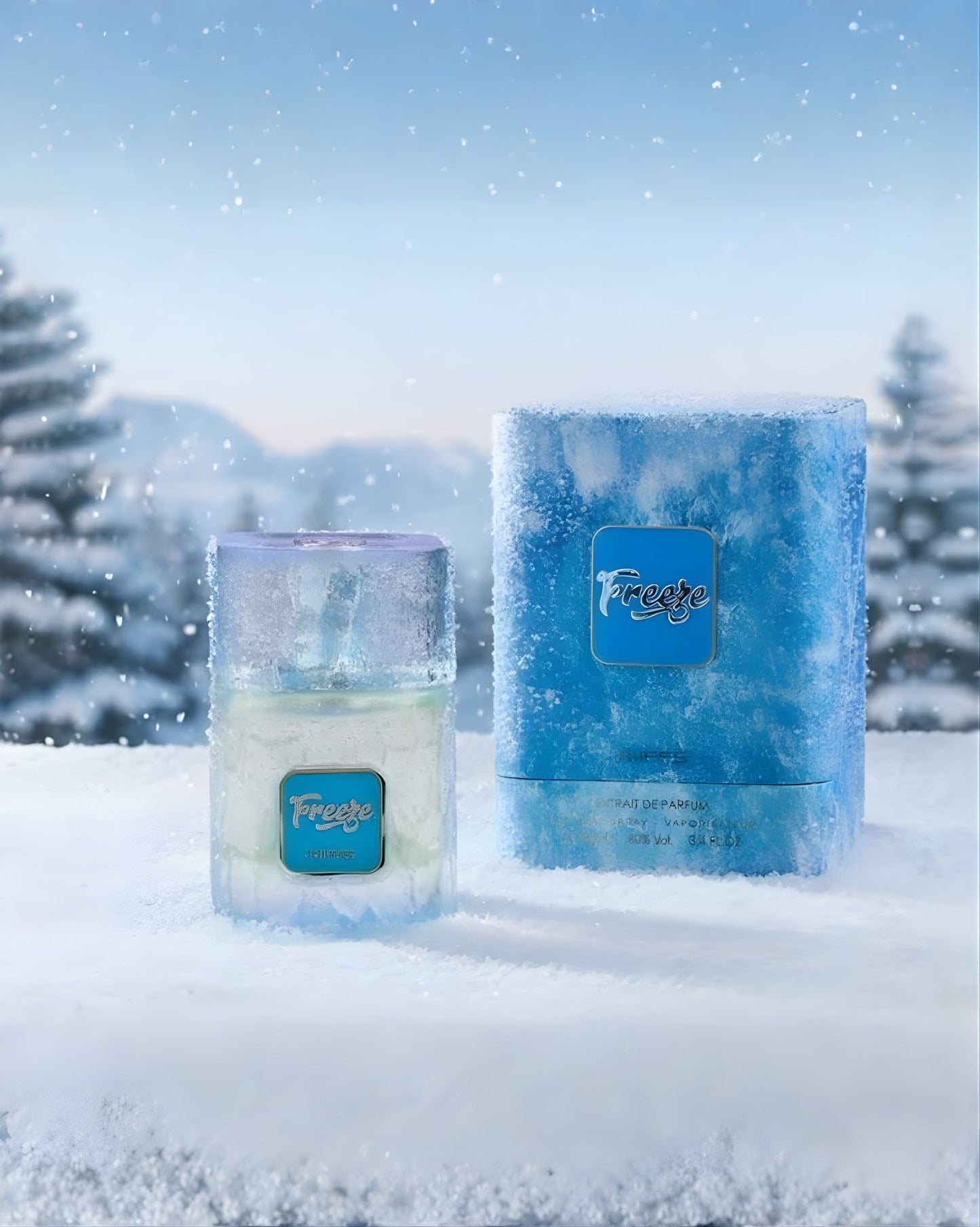 A product photo of the RIIFFS Freeze EXtrait de parfum fragrance bottle and its box set outdoors on a snowy surface. The background features blurred snowy pine trees and mountains under a bright sky with falling snow, enhancing the "freeze" theme.