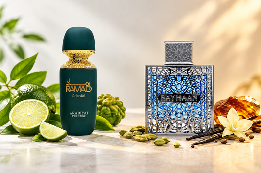 Arabiyat Prestige Ramad Oriental matte green bottle and Rayhaan Eau de Parfum blue latticed bottle set with sliced limes, bergamot, cardamom pods, vanilla beans, and amber resin.