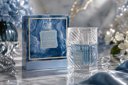 Lattafa Khamrah Waha Eau de Parfum clear cut-glass bottle displayed next to its blue marble-patterned presentation box.