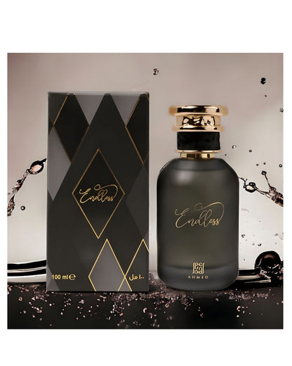 A dramatic, high-contrast product photo of AHMED "Endless" Eau de Parfum, 100ml, showing the dark bottle and its matching black, gold, and gray diamond-patterned box. The presentation is dynamic, with splashes of dark liquid and a sleek, reflective surface, creating a sophisticated and luxurious atmosphere.