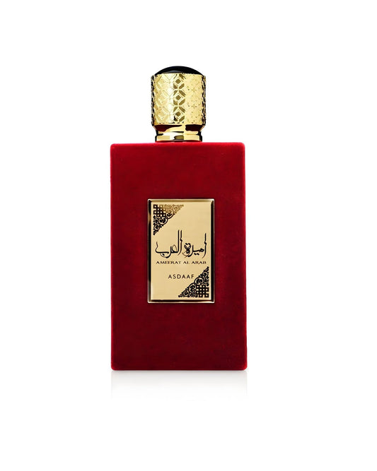 A rectangular red velvet perfume bottle with a gold label featuring Arabic script Ameerat Al Arab Edp and the brand name ASDAAF. The cap is gold with an intricate embossed pattern.