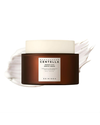 SKIN1004 Madagascar Centella Probio-Cica Enrich Cream jar in dark brown and white, centered on a white background with a white cream swatch behind it, illustrating the product texture.