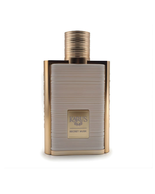 A sophisticated rectangular perfume bottle labeled "khadlaj Karus Secret Musk," featuring a gold metallic frame, a gold ridged cap, and a central panel in textured beige or off-white, isolated against a white background.