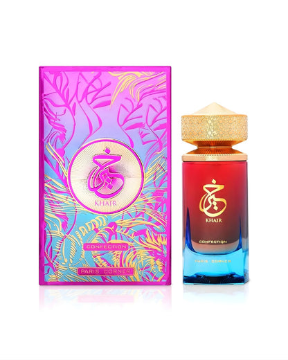 The Paris Corner Khair Confection bottle next to its brightly colored, foil-stamped box featuring an abstract botanical design in pink, blue, and gold.