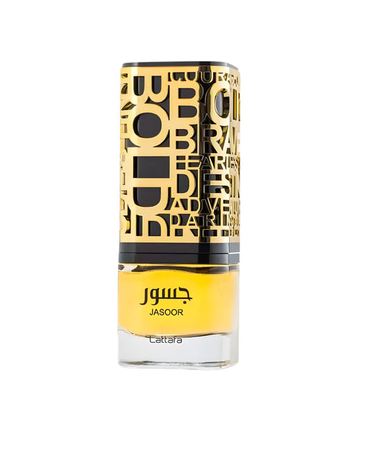 A bottle of Lattafa Jasoor perfume. The glass bottle contains a yellow liquid and has a distinctive black and gold cap with cutouts of stylized English words like 'BOLD' and 'BRAVE'.