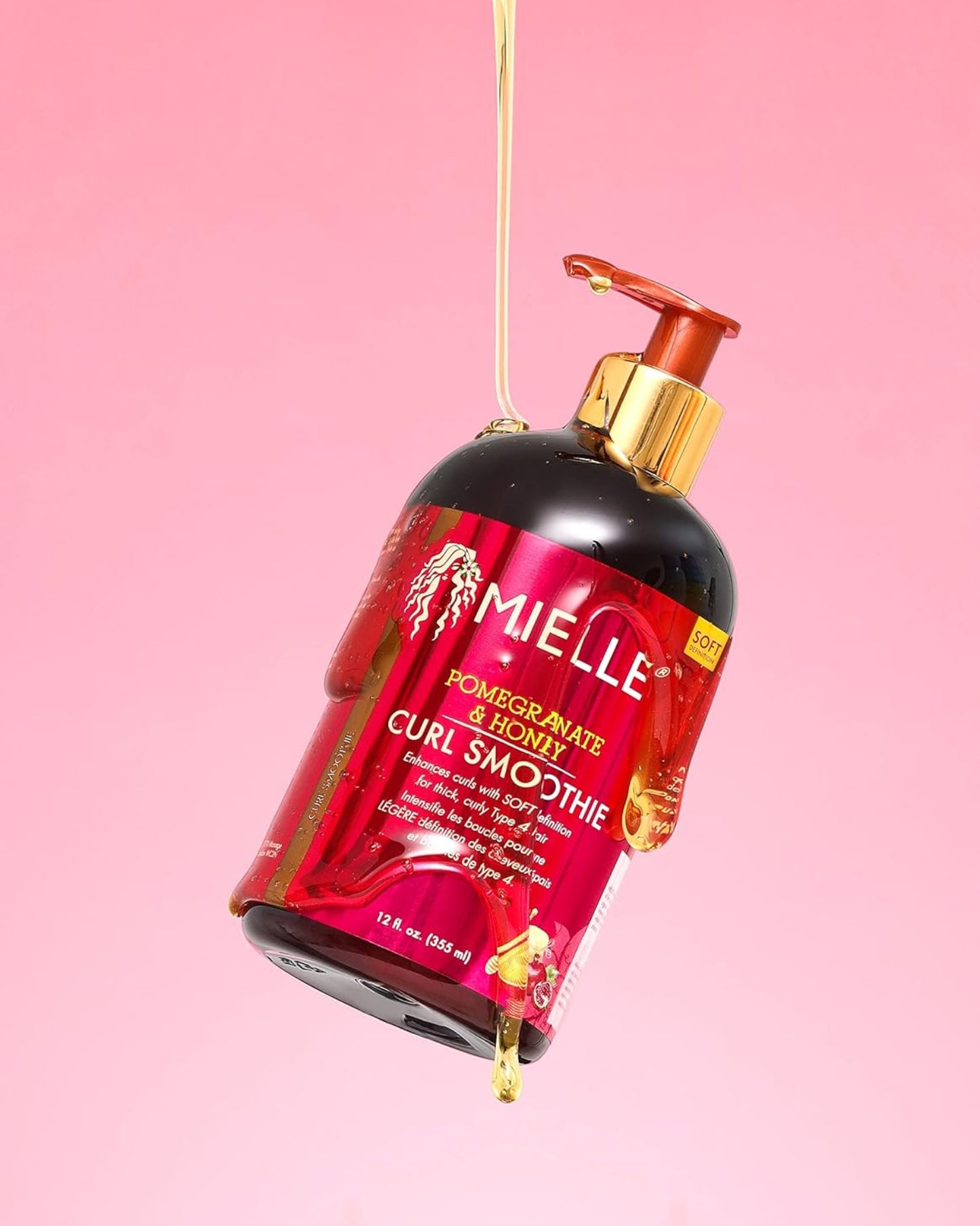 Mielle Organics Pomegranate Honey Leave In Conditioner bottle photograph with fallen honey