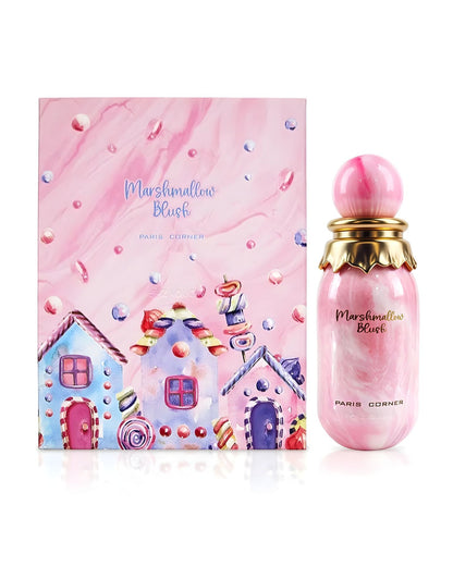 A box featuring the Paris Corner Marshmallow Blush Edp perfume bottle and its corresponding box. The box is pink and white marbled with a watercolor illustration of colorful gingerbread-style candy houses and scattered marshmallows. The perfume bottle is pink marbled with a gold scalloped collar and a round pink cap.