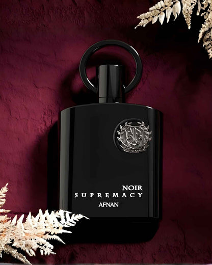 Luxury presentation of Afnan Supremacy Noir Eau de Parfum for men, featuring the signature black bottle and silver crest.