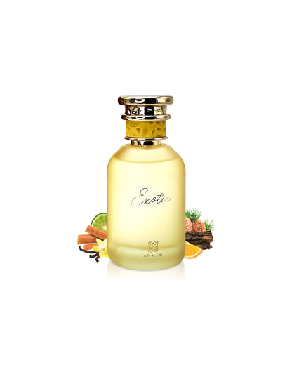 Frosted yellow glass perfume bottle labeled "Exotic" by Ahmed, surrounded by the perfume's potential ingredients, including cinnamon sticks, vanilla bean, lime, orange slice, and wood chips.