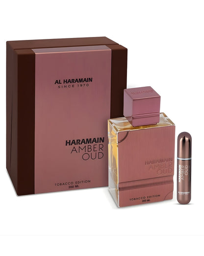 Al Haramain Amber Oud Tobacco Edition 200ml perfume set featuring the copper-tone metallic bottle, the premium display box, and a matching travel atomizer spray.