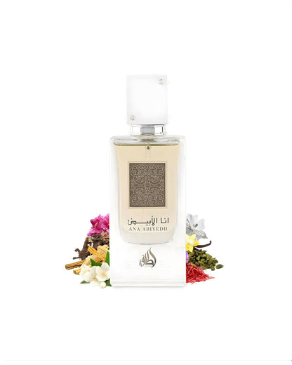 The rectangular 'Ana Abiyedh' perfume bottle with a white cap is surrounded by a pile of various raw fragrance ingredients, including saffron threads, cardamom pods, vanilla beans, small white and pink flowers, and pieces of wood/cinnamon sticks.