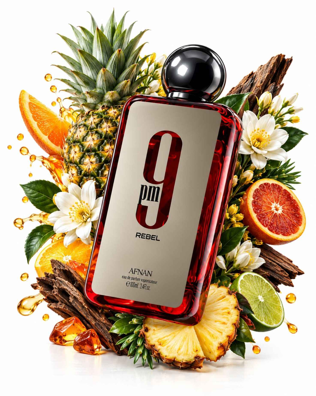 Afnan 9 PM Rebel Eau de Parfum bottle surrounded by vibrant pineapple, sliced blood orange, lime, white blossoms, and aromatic wood bark with splashing juice drops against a white background.