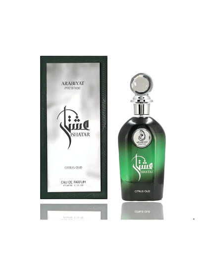 The Arabiyat PrestigeIshatar Citrus Oud Edp bottle, with its black-to-green gradient and iridescent stopper, is displayed next to its matching presentation box. The box has a dark green frame and a reflective silver panel featuring the perfume name and logo.