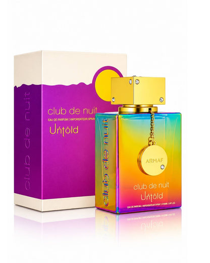 Armaf Club de Nuit Untold Eau de Parfum iridescent rainbow bottle with a gold cap standing beside its purple, white, and yellow packaging box on a reflective white surface.