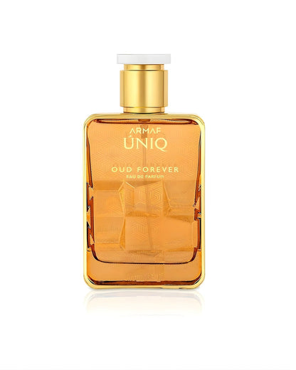 A rectangular Armaf Uniq Oud Forever Eau de Parfum bottle in a reflective gold finish, featuring a textured geometric pattern on the body and a gold cap with a white top, isolated against a white background.