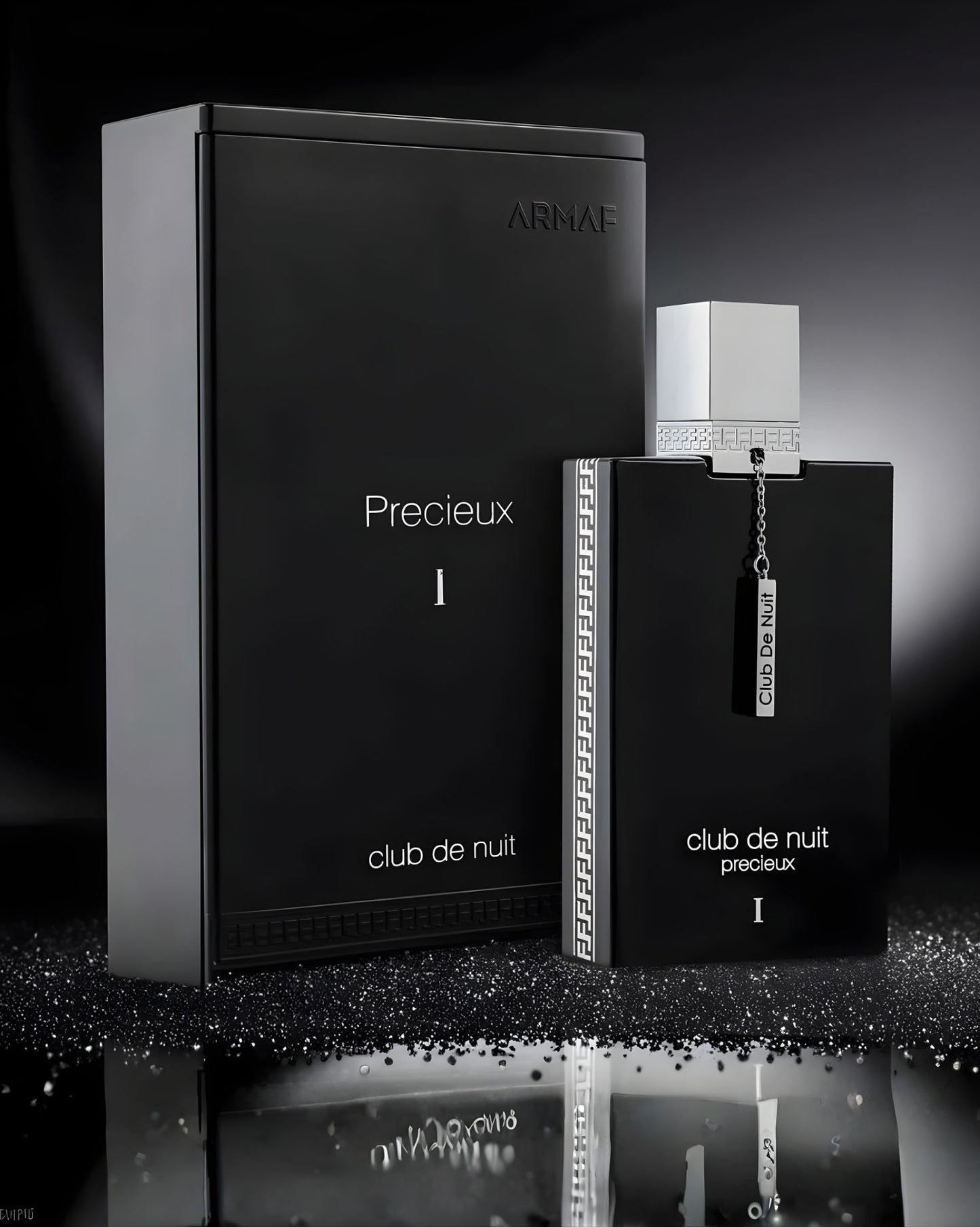A high-contrast, black and silver still life product shot of the Armaf Club De Nuit Precieux 1 EXdp perfume bottle and its luxury rectangular box on a reflective surface with sparkling glitter.