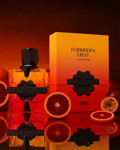 Product lifestyle photo of French Avenue Aromatix Forbidden Fruit ExDP perfume bottle surrounded by sliced blood oranges and passionfruit on a reflective red surface.