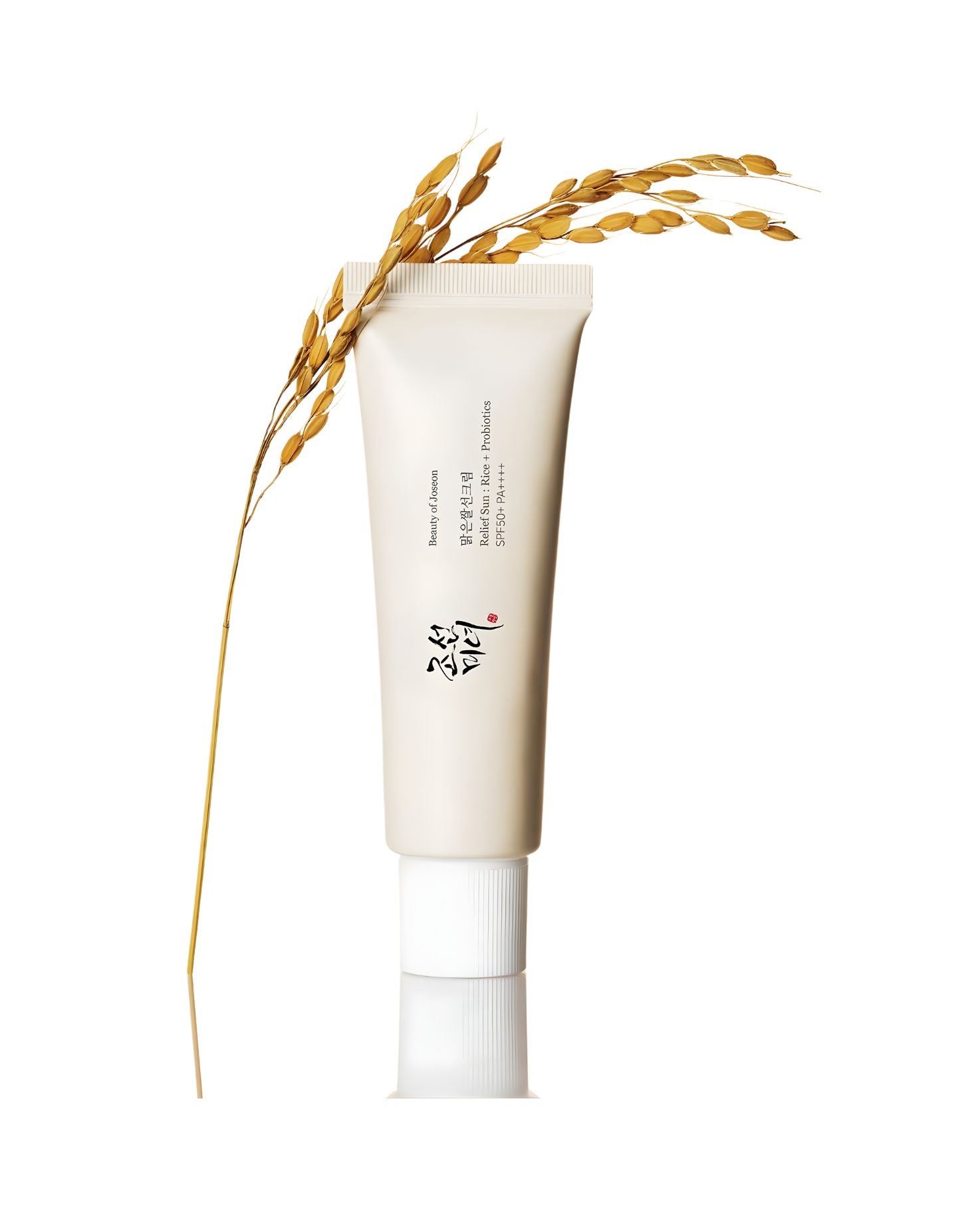 Beauty of Joseon Relief Sun: Rice + Probiotics SPF 50+ PA++++ tube, standing upright with a stalk of golden rice ears draped across the top, set against a white background.