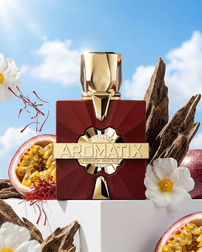 French Avenue Aromatix Carnal Desire ExDP perfume bottle displayed outdoors with passionfruit, saffron strands, white flowers, and oud wood pieces against a blue sky.