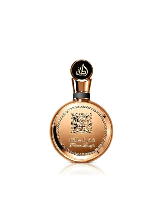A stunning, circular Lattafa "Fakhar Lattafa" perfume bottle, featuring an entirely gold or copper-toned body with a large ornate central emblem and a decorative rope-chain border, isolated against a white background.