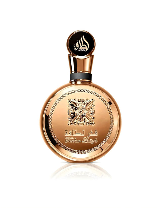 A stunning, circular Lattafa "Fakhar Lattafa" perfume bottle, featuring an entirely gold or copper-toned body with a large ornate central emblem and a decorative rope-chain border, isolated against a white background.