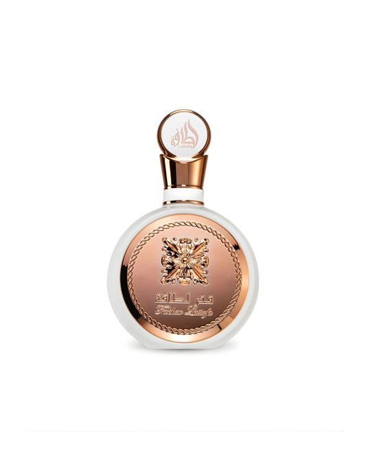 A sleek, circular Lattafa "Fakhar Lattafa" perfume bottle, featuring a white body encased by a striking rose gold panel with an ornate central emblem and chain-link border, against a white background.
