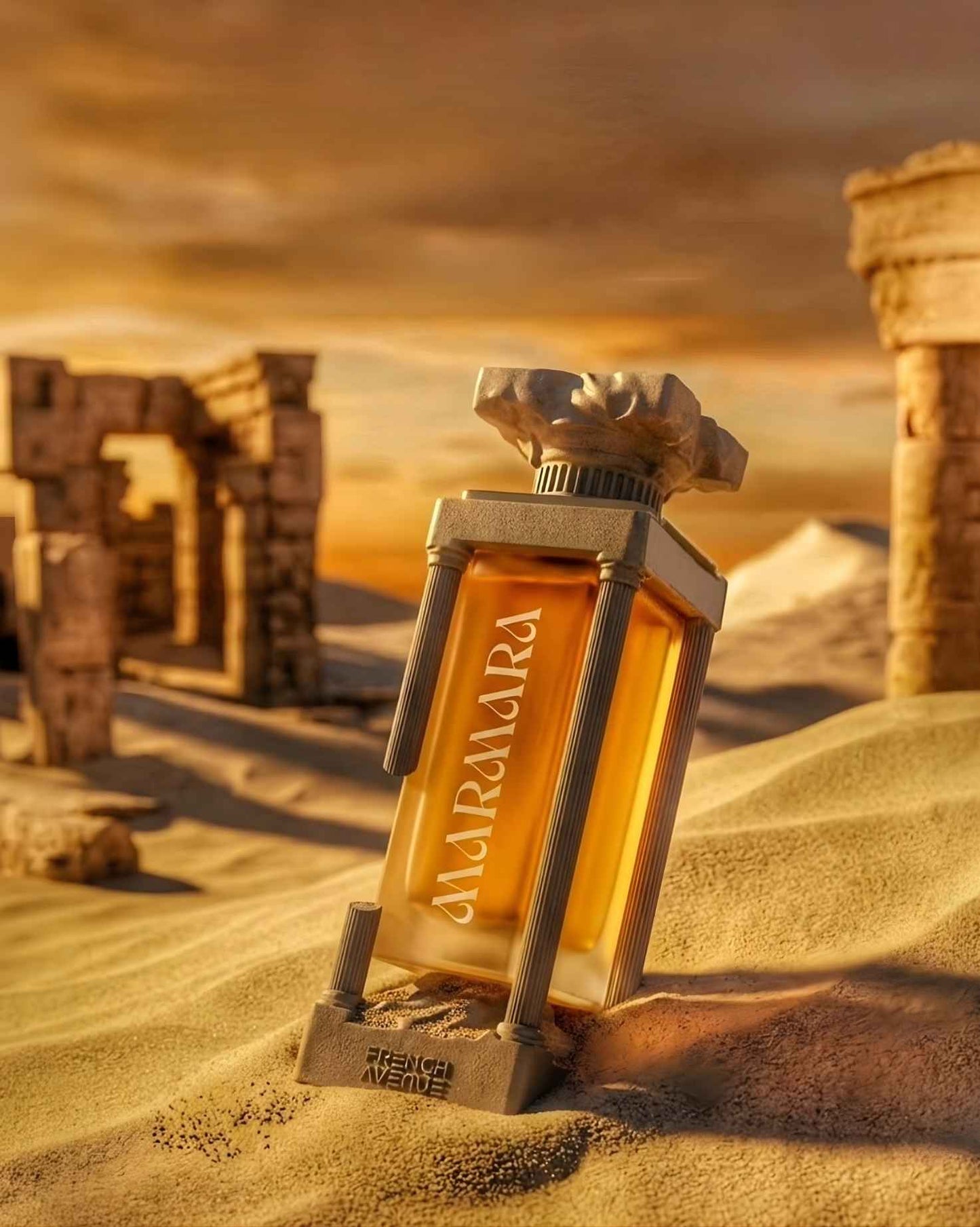 Marmara Extrait de Parfum by French Avenue in its signature Greek column-shaped bottle, resting in golden desert sand dunes with ancient ruins in the background at sunset.