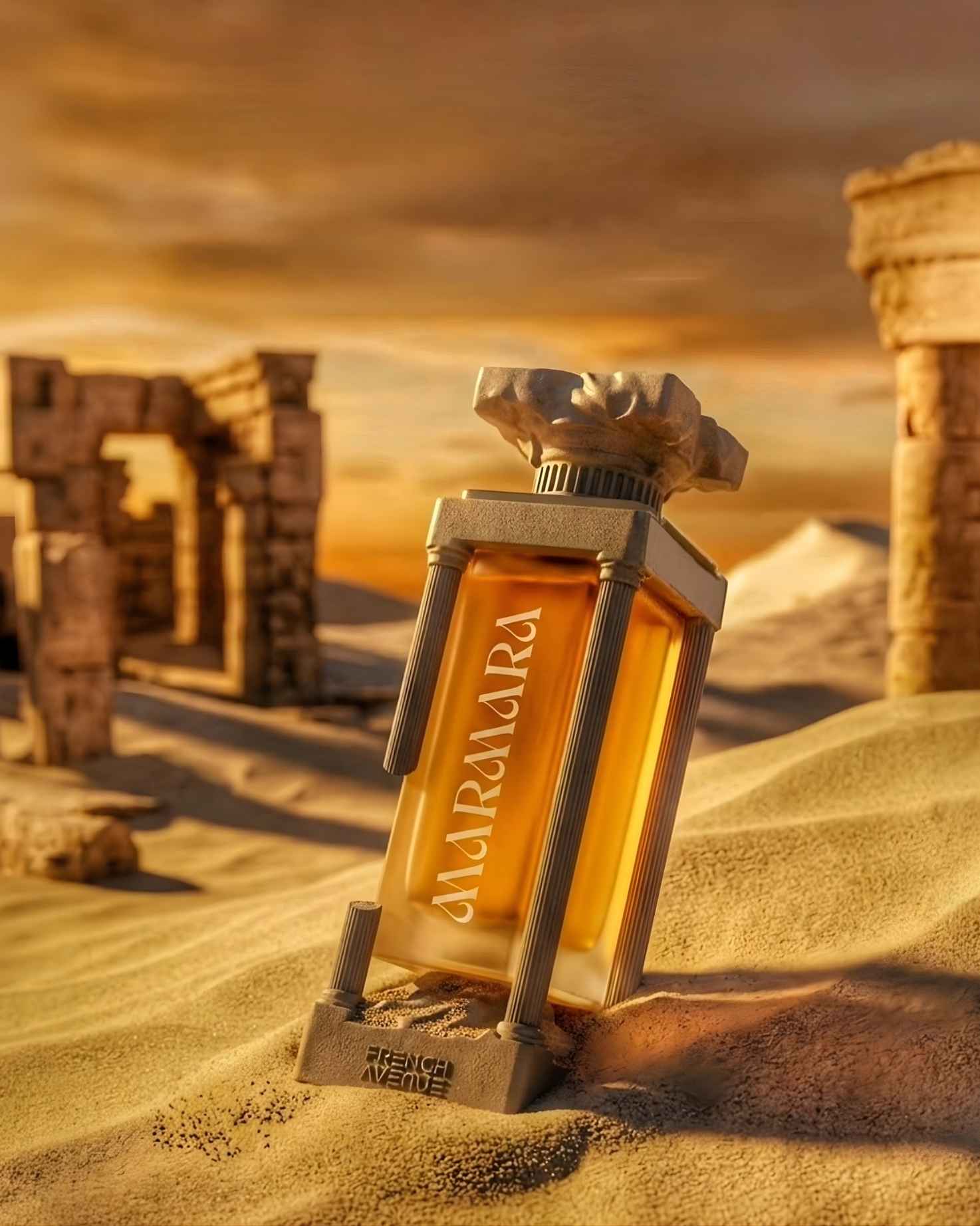 Marmara Extrait de Parfum by French Avenue in its signature Greek column-shaped bottle, resting in golden desert sand dunes with ancient ruins in the background at sunset.