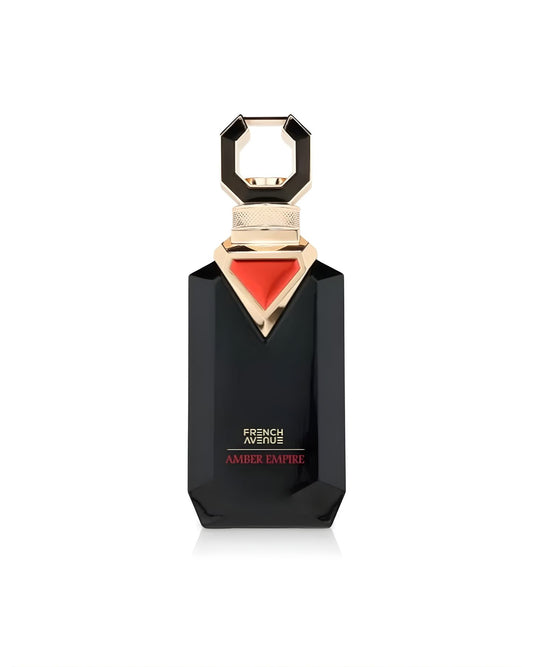A black, faceted perfume bottle with a bold, golden geometric cap and an inverted red triangle design below the neck. The label reads 'FRENCH AVENUE AMBER EMPIRE' in white and red text, isolated against a white background.