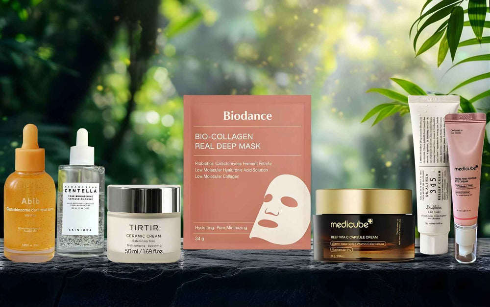Group shot of viral K-beauty products: Biodance collagen mask, Medicube Vita C capsule cream, Tirtir ceramic moisturizer, and Skin1004 brightening ampoule.