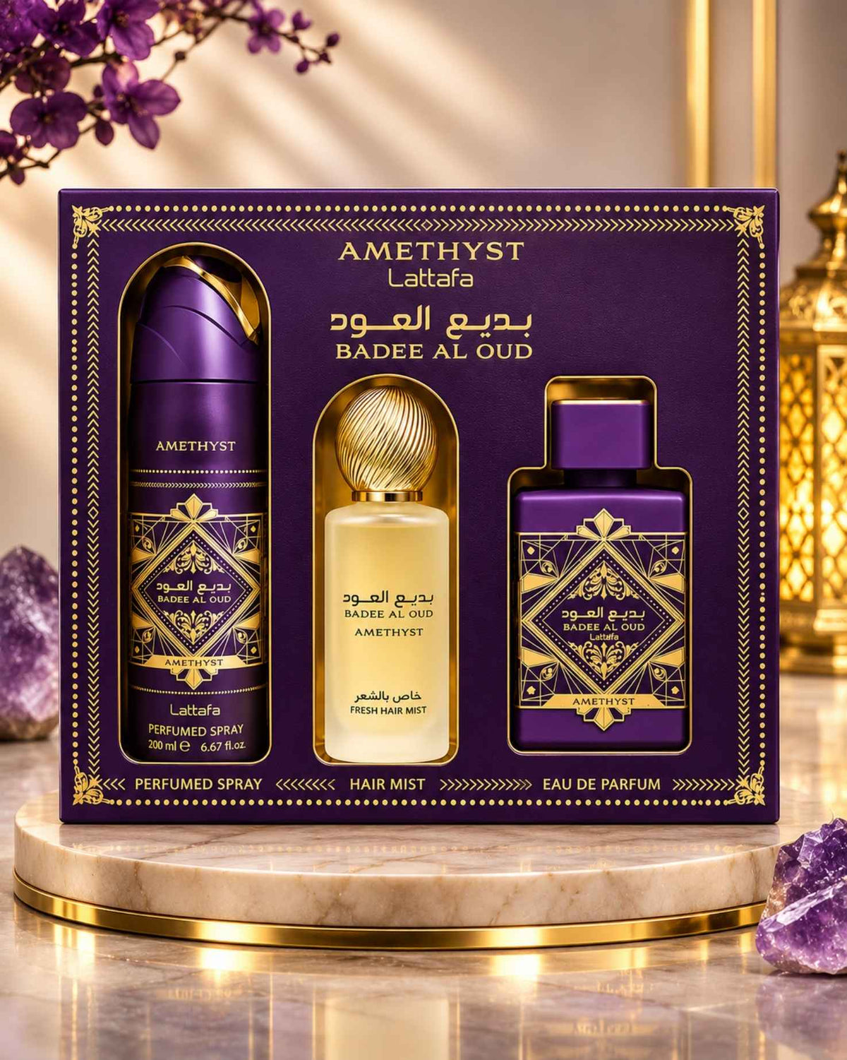 Lattafa Bade'e Al Oud Amethyst 3-piece fragrance gift set box presented on a round marble pedestal surrounded by purple amethyst crystals, delicate purple flowers, and warm ambient lighting.