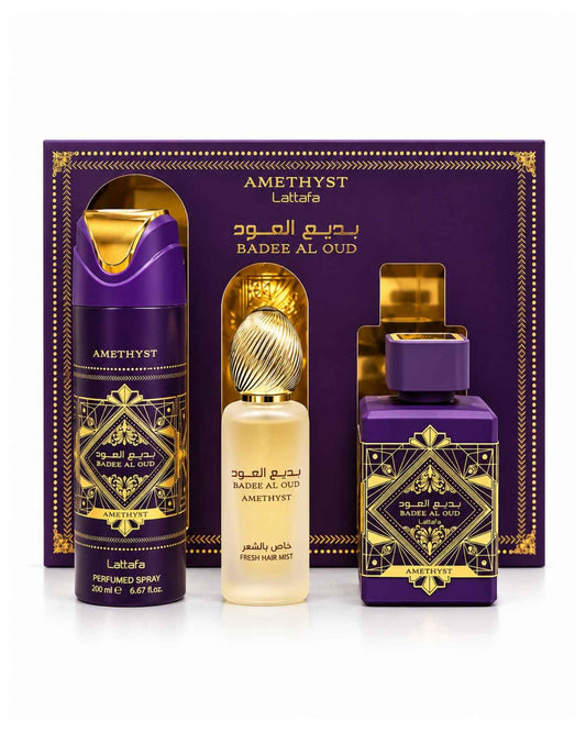 Lattafa Bade'e Al Oud Amethyst gift set with the purple Eau de Parfum bottle, fresh hair mist, and 200ml perfumed body spray displayed standing outside their open purple and gold presentation box.