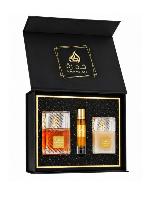 Lattafa Khamrah luxury perfume gift set open black box containing full-size fragrance bottle, travel spray, and body lotion against a speckled black inlay.