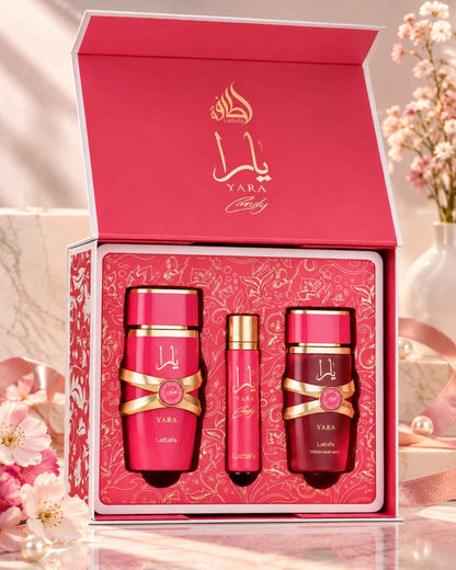 Lattafa Yara Candy perfume gift set in an open pink display box on marble, surrounded by pink cherry blossoms and satin ribbon.