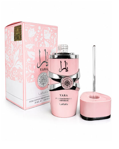 Lattafa Yara Pure Concentrated Perfume Oil 20ml bottle shown unboxed next to its pink floral packaging and glass applicator cap.
