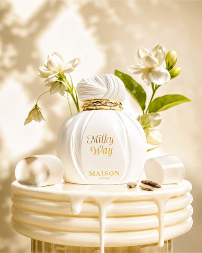 Maison Asrar Milky Way Eau de perfume bottle styled with white flowers, marshmallows, and creamy accents.