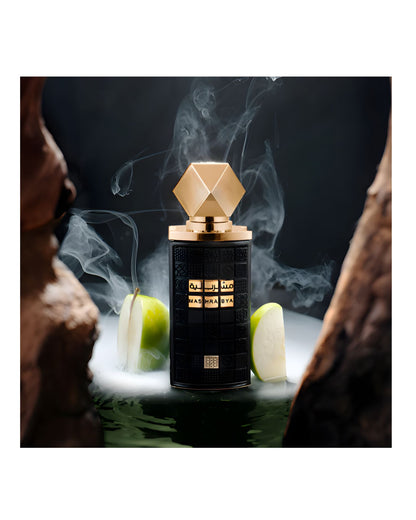 Dramatic product photo of the textured black Mashrabya bottle with a gold cap, framed by natural wood and sliced green apples, giving a fresh, earthy, and mysterious feel.