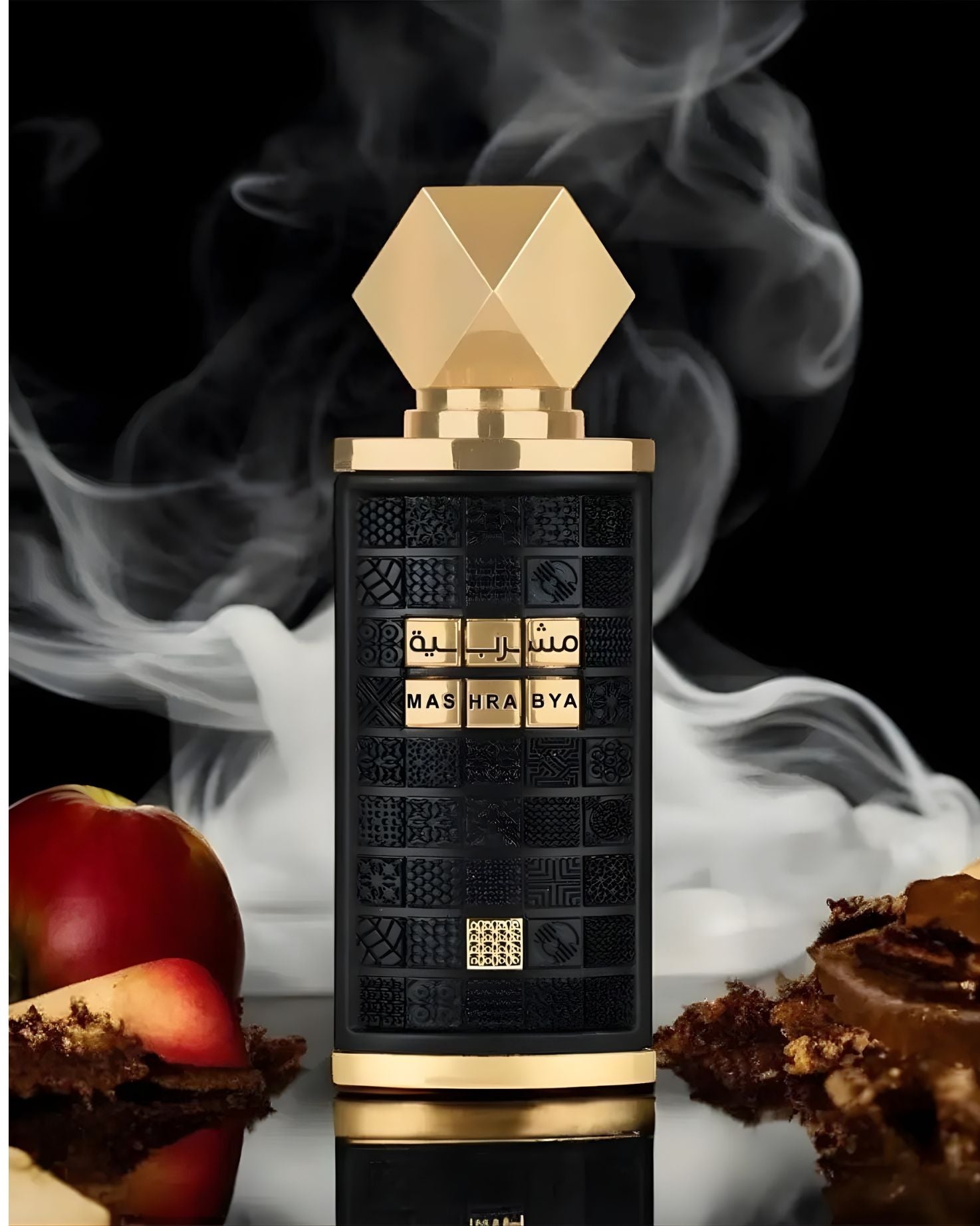 A dramatic close-up of the textured black Mashrabya fragrance bottle with its geometric gold cap, surrounded by smoke and props like apple slices and cake, giving a mysterious, rich, and edible feel.