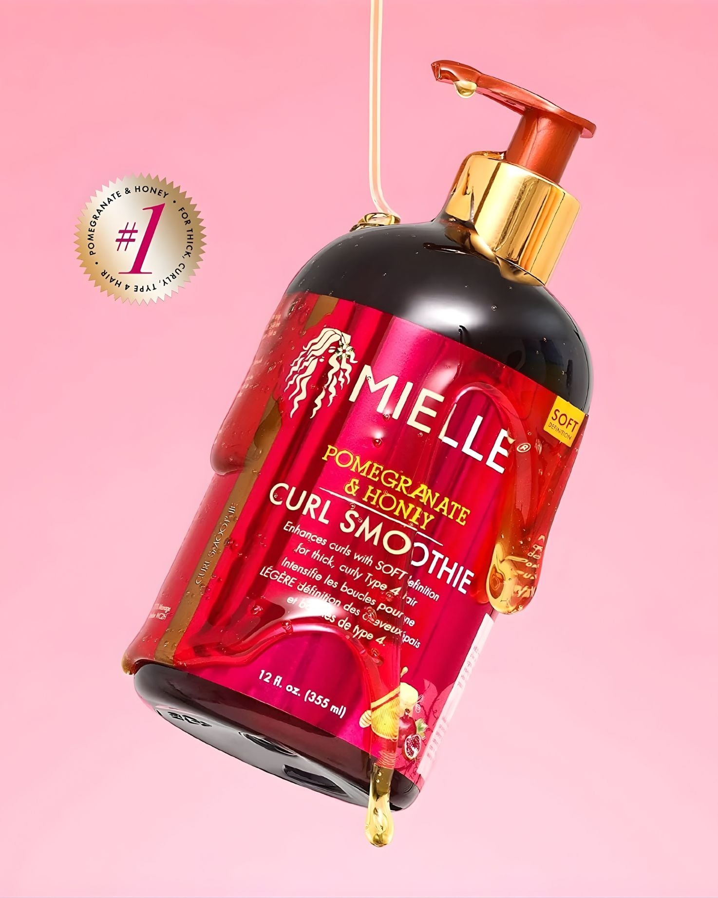 A bottle of Mielle Pomegranate & Honey Curl Smoothie tilted dramatically against a pink background, covered in dripping honey. A circular badge in the upper left corner features a number one symbol and reads "#1 FOR THICK, CURLY, TYPE 4 HAIR.