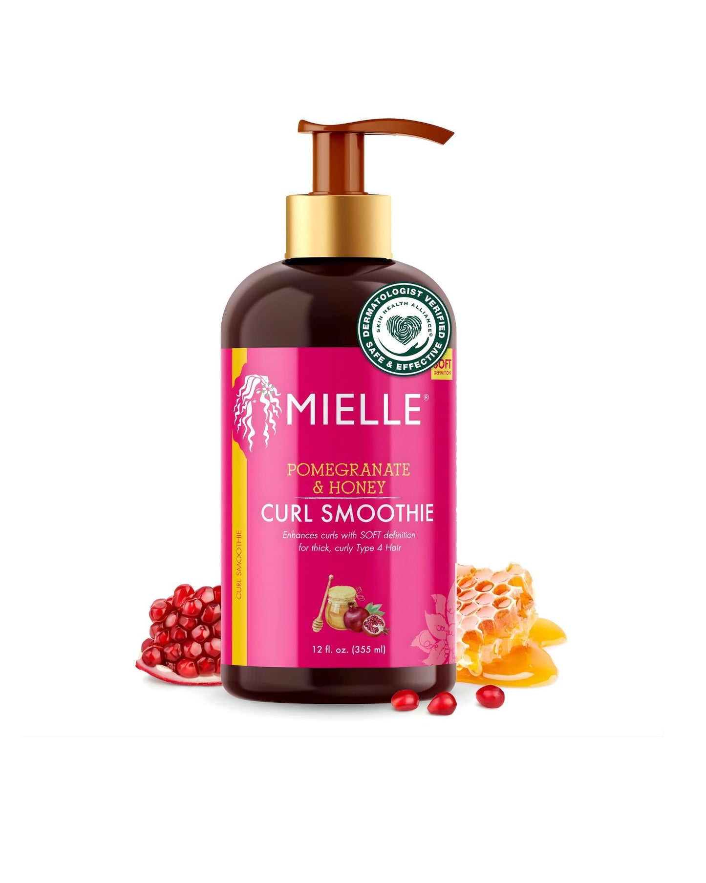 A bottle of Mielle Pomegranate & Honey Curl Smoothie. The pump-top bottle is dark brown with a bright pink label. The label states "POMEGRANATE & HONEY CURL SMOOTHIE" and says it "Enhances curls with SOFT definition for thick, curly, type 4 hair." The bottle is surrounded by a halved pomegranate, a slice of honeycomb, and loose honey.