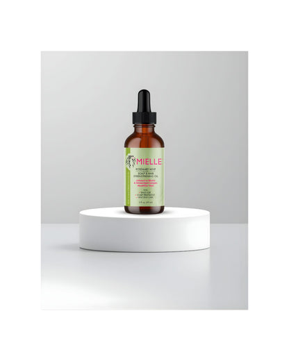 Mielle Rosemary Mint Scalp and Hair Strengthening Oil dropper bottle displayed on a white product stand.
