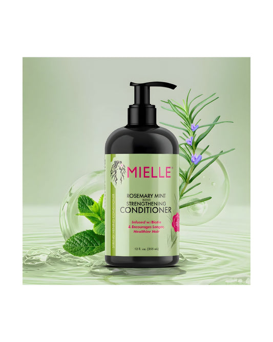 Mielle Organics Rosemary Mint Strengthening Conditioner, a 12 fl. oz. bottle infused with Biotin, displayed against a light green background with sprigs of fresh rosemary and mint leaves, emphasizing ingredients for longer, healthier hair.