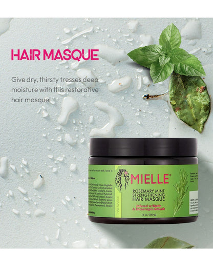 An advertisement for the Mielle Rosemary Mint Strengthening Hair Masque, featuring the jar partially submerged in water or moisture drops on a light green surface. The headline reads 'HAIR MASQUE,' and the text encourages using it to 'Give dry, thirsty tresses deep moisture.' A large sprig of fresh mint leaves is visible in the top right corner.