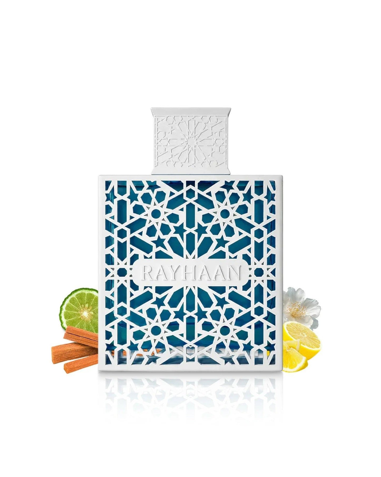 A bottle of Rayhaan Azul perfume with white geometric casing and blue liquid, surrounded by fragrance note ingredients including a lime slice, cinnamon sticks, lemon slices, and a white jasmine flower.