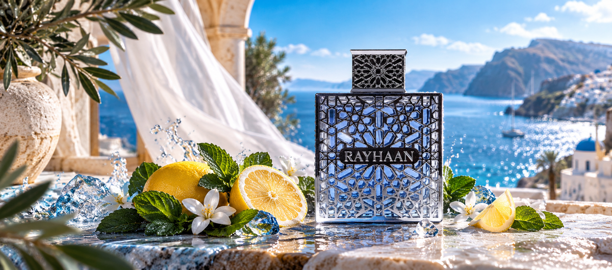 Rayhaan Eau de Parfum bottle with intricate blue geometric lattice casing displayed on a stone ledge with lemons, mint leaves, ice cubes, and white blossoms against a Mediterranean seaside backdrop.