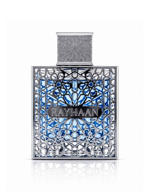 Rayhaan perfume bottle filled with light blue liquid inside an ornate silver cage with geometric lattice work.